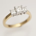 Three well-balanced Princess cut Diamonds, totalling 0.80 carats in 18ct 'Trilogy' mount